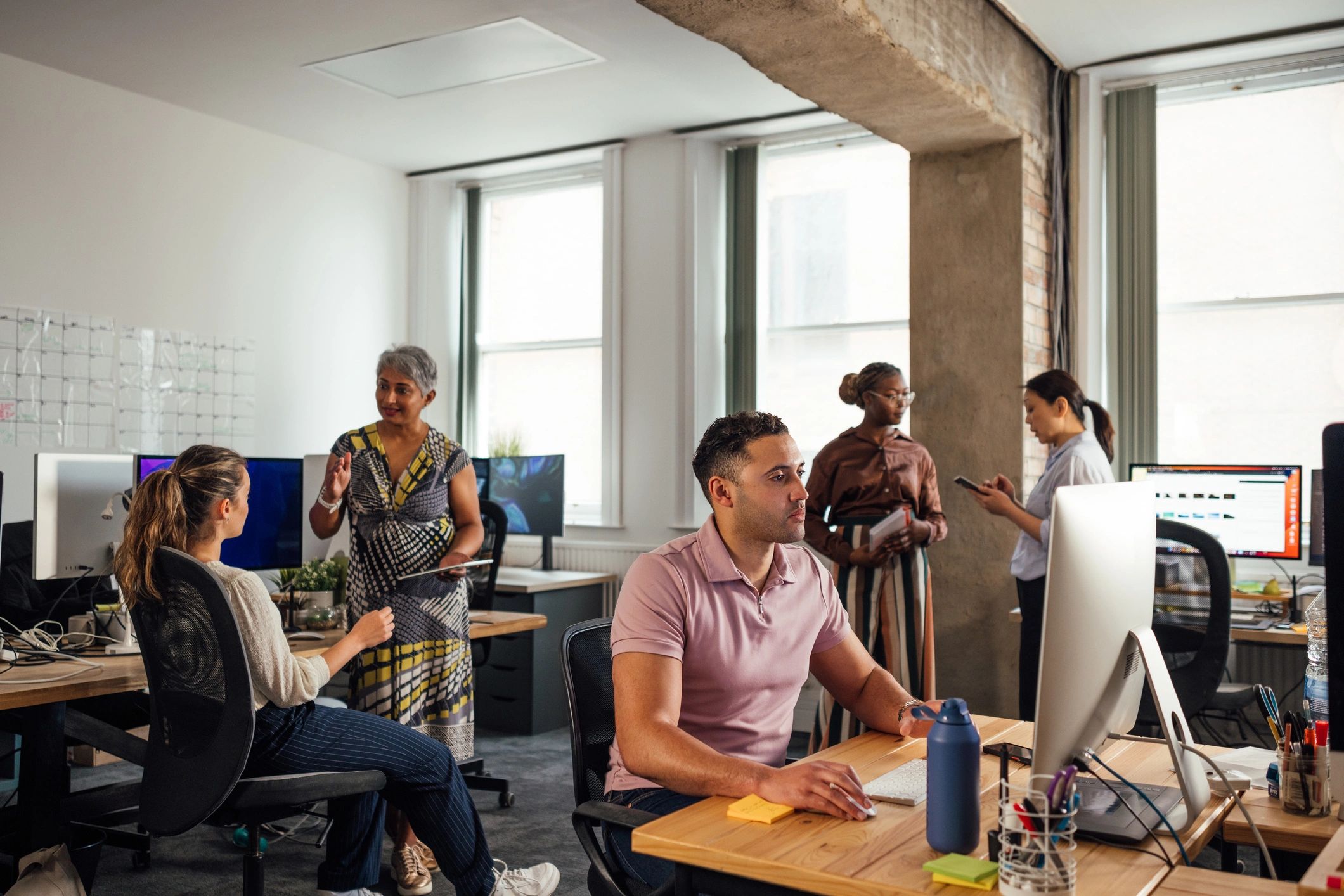 Cybersecurity team collaborating in an office workspace
