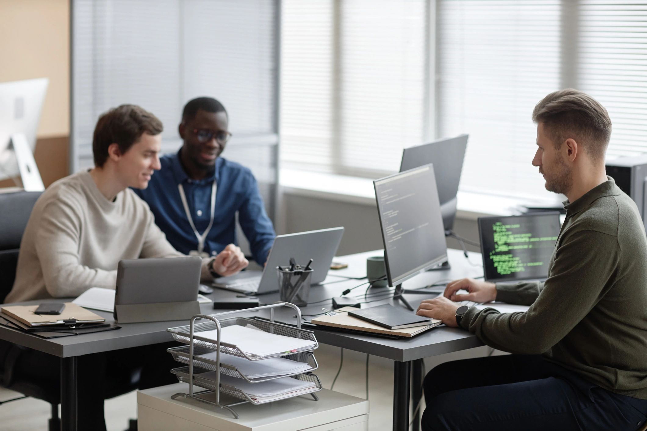 IT professionals working together in a modern cybersecurity office