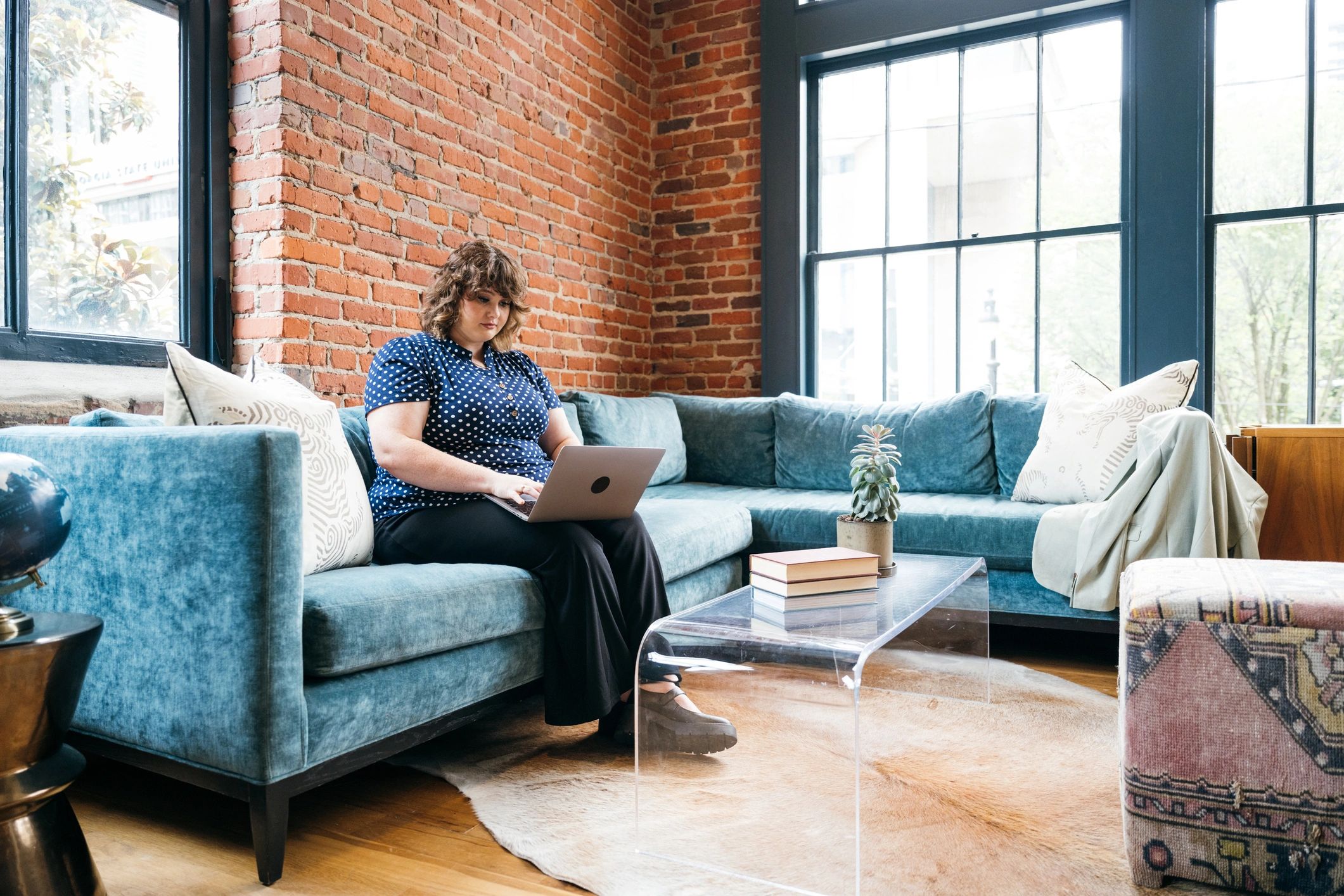 Business woman working on laptop in office lounge